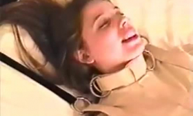 Gagged teen brunette is getting fucked while a chains are tied up around her legs.