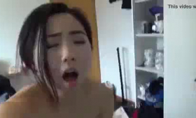 Beautiful Asian girl bends over and takes off her bikini while her boyfriend is watching her.