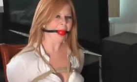 Gagged redhead slave was tied in a hogtie and spit ball gag midstream